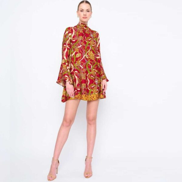 A model showcases a vibrant red and gold print dress.