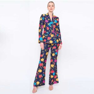 A model showcases a vibrant floral suit, featuring a colorful floral pattern.